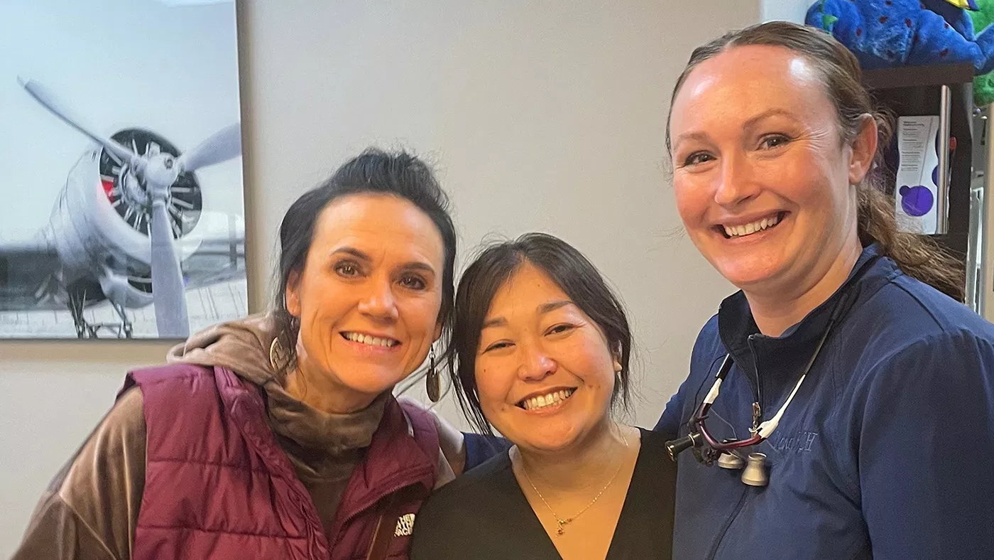 The image shows a hand holding a tablet with a star rating graphic on the screen, indicating high customer satisfaction or approval.